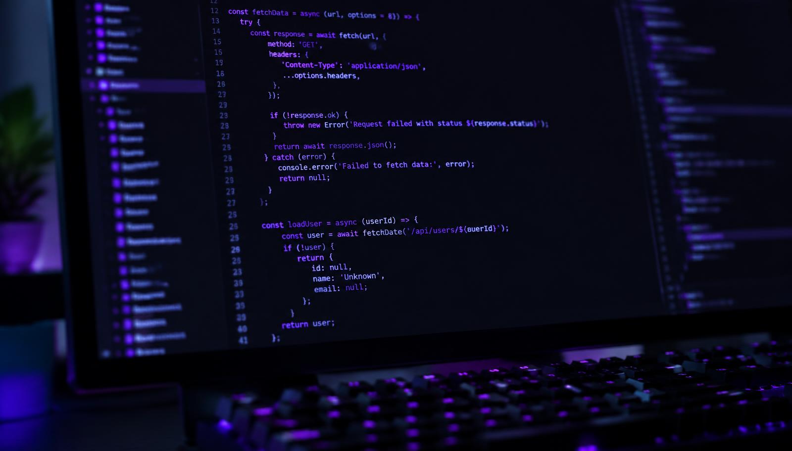 Code editor with violet syntax highlighting on a monitor
